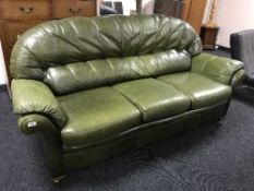 A green leather three seater settee