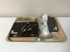 A tray containing boxed and unboxed stainless steel and plated flatware