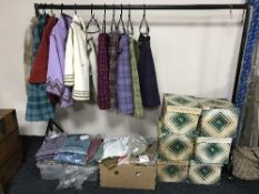 A quantity of vintage lady's cloths including woollen skirts with capes, woollen skirts, hats,
