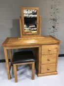 A contemporary pine dressing table with matching mirror and stool