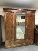A Victorian mahogany triple door wardrobe with fitted interior