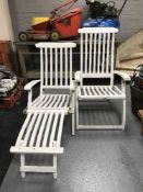 A pair of painted teak garden loungers