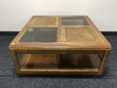 A large square colonial style coffee table inset glass panels