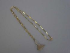 An antique agate seal fob suspended upon a gold chain