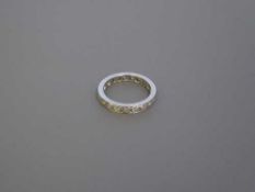 A platinum and diamond eternity ring