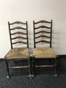 A pair of early 20th century ladder back kitchen chairs