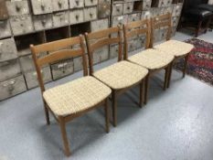 Four teak dining chairs