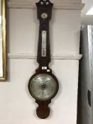 A Victorian inlaid mahogany banjo barometer with silvered dial
