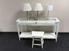 An Ikea console table and three table lamps