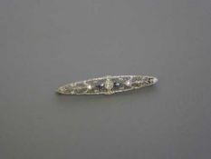 An Art Deco 14ct white gold diamond and sapphire bar brooch, length 58mm, 4.2g.