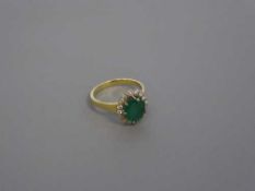 An 18ct gold emerald and diamond cluster ring, size O, 4.5g.