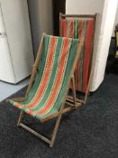 A pair of mid 20th century folding deck chairs
