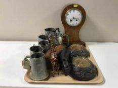 A tray containing an early 20th century inlaid balloon mantel clock, wooden candle holders,