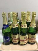 A tray containing twelve bottles of wine and demi-sec including seven bottles of Charmaine,