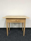 An oak topped work table on pine base fitted a drawer