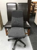 A pair of brown leather high back chairs and a swivel typist's chair