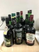 A tray containing twelve bottles of alcohol including Irish and English Cream, ginger wine,