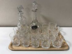 A tray containing lead crystal decanters and whisky tumblers