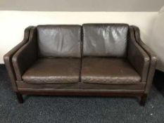 A late 20th century brown leather two seater settee