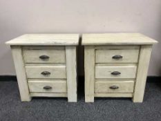 A pair of painted pine three drawer chests (2)