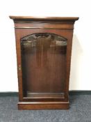 A mahogany Bradley glazed door curio cabinet
