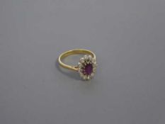 An 18ct gold ruby and diamond cluster ring, size N-O, 4.1g.