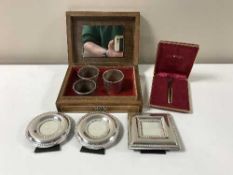 An inlaid trinket box containing plated picture frames, napkin rings,