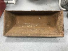 A cast iron garden trough