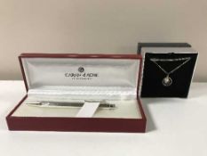 A boxed Van Peterson silver necklace together with a boxed Caran D'ache pen