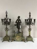 A three piece spelter and marble clock garniture