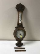 A carved oak banjo barometer