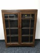 An oak glazed door bookcase