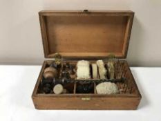 A gun cleaning kit in a fitted pine box