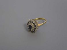 An 18ct gold diamond and sapphire cluster ring, size P, 7.8g.
