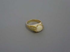 A 14ct gold opal ring set with diamond shoulders, size N, 4.9g.