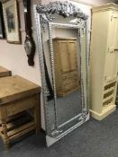 A large contemporary silvered floor standing mirror,