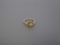 An 18ct gold diamond cluster ring, the central stone estimated at 0.