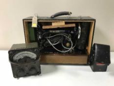 A cased Singer sewing machine together with a Bakelite cased avometer,