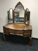 A walnut shaped dressing table with mirror