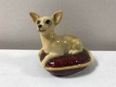A Beswick Chihuahua on red cushion