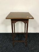 A square topped occasional table on oak legs