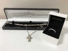 A silver bracelet with cross together with a boxed Pandora ring