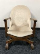 A mid 20th century oak framed nursing chair