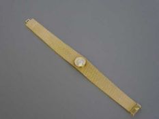 A lady's 18ct gold Omega wrist watch, upon a 14ct gold integral Omega bracelet, in Omega box, 51.3g.