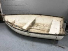 A fibre glass boat with oar