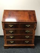 An inlaid mahogany bureau and matching TV stand