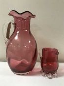 Two cranberry glass jugs