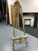 An over sized cream and gilt artist's easel