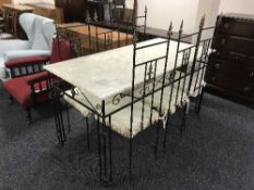 A marble and wrought iron topped dining table and six high backed chairs