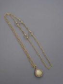 A fine Victorian crystal backed 'shell' locket with seed pearl border,